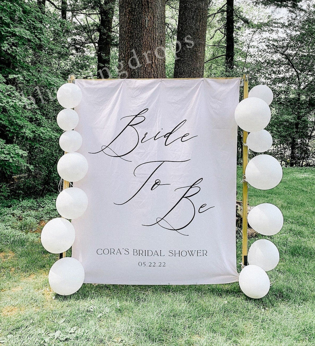 Bride to be sign with balloon arch in a forest setting
