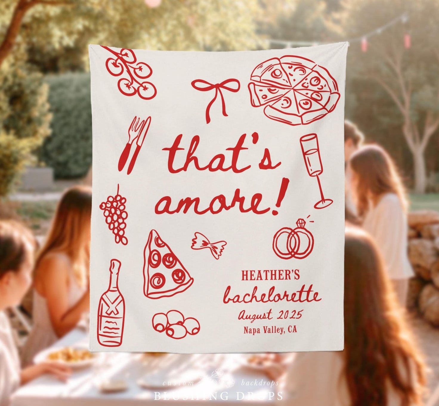 Decorative sign with 'that's amore!' text and bachelorette party details, with people in the background at a table.