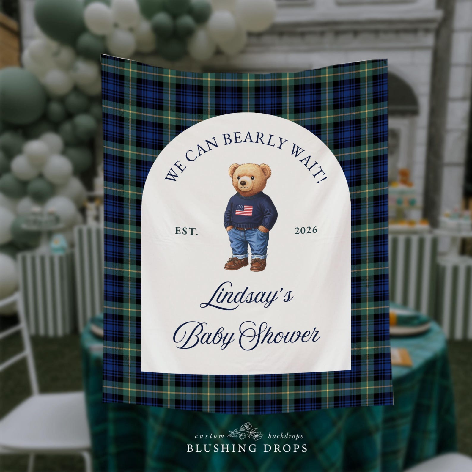 Baby shower sign with teddy bear graphic and text on a plaid background